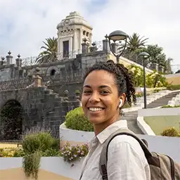 A girl listening to an immersive audio guide at the Masonic mausoleum in the Victoria Gardens, La Orotava