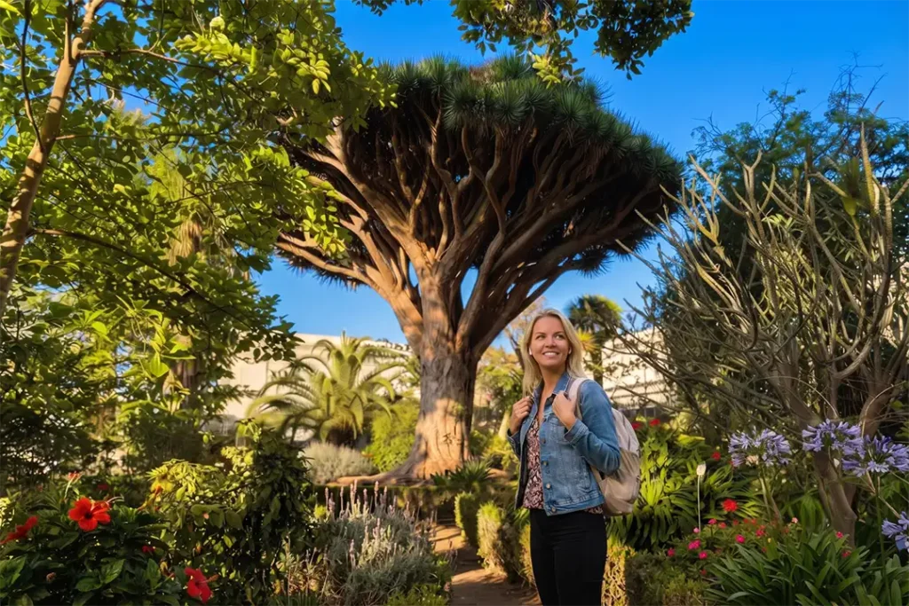 A traveller listening to an audio guide at La Hijuela in the Botanical Gardens, La Orotava, Tenerife