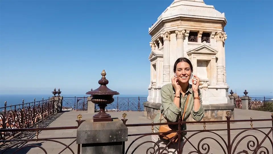 A woman enjoying an immersive audio experience at the Masonic Mausoleum in the Victoria Gardens, La Orotava, Tenerife